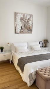 a bedroom with a large bed and a painting on the wall at La ROMANTICA VERONA in Verona