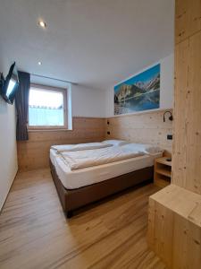 a bedroom with a large bed and a window at Bait da Pemont in Livigno