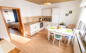 a kitchen and dining room with a table and chairs at Haus Kallin in Idar-Oberstein