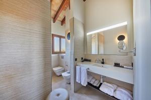 a bathroom with a sink and a toilet and a mirror at Virrey Finca Hotel in Inca
