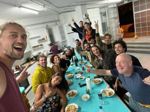 a group of people sitting around a table at Medano Nest Hostel in El Médano