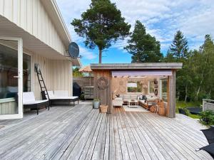 a wooden deck with a pavilion on a house at 6 person holiday home in Åsenfjord-By Traum in Hopla