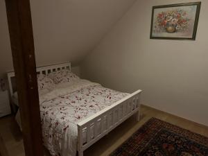 a small bedroom with a bed with a white bedspread at Haylenes in Tourcoing