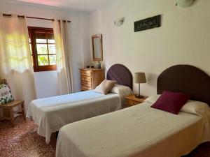 a hotel room with two beds and a window at Casa Los Palitos in Monte de Breña +53 photos