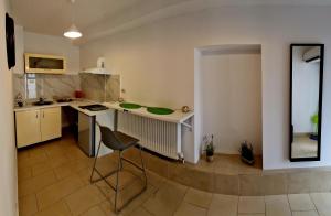 a kitchen with a table and a chair in a room at MBI Smart Central in Craiova