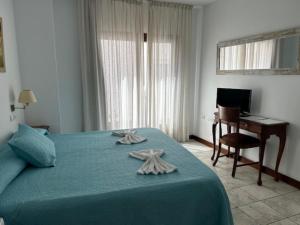 Postel nebo postele na pokoji v ubytování Hotel Al-Andalus