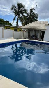 une grande piscine bleue en face d'une maison dans l'établissement Shero Villa, à Flic-en-Flac