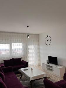 a living room with a couch and a coffee table at Cosy Apartment with a Great View in Prishtinë