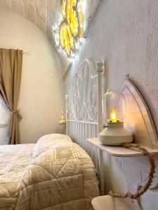 a bedroom with a bed with a lamp on a table at Il Pumo Rosa - Puglia Mia Apartments in Monopoli