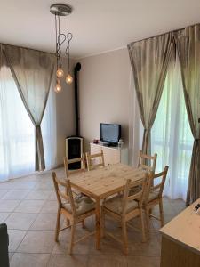 a dining room with a wooden table and chairs at La Pepita in Vallo Torinese