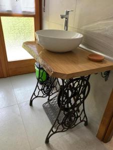 a large bowl sink on a wooden table in a bathroom at La Pepita in Vallo Torinese