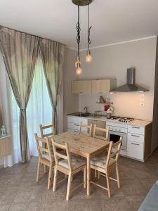 a kitchen with a wooden table and chairs in a kitchen at La Pepita in Vallo Torinese