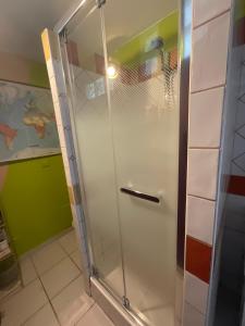 a shower with a glass door in a bathroom at MAISON indépendante VUE MER au cœur de la NATURE in Toulon