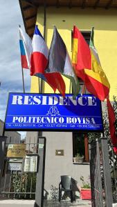 un cartel con banderas delante de un edificio en Residence Politecnico Bovisa, en Milán