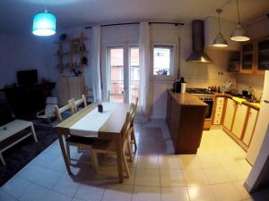 a kitchen with a wooden table and a dining room at Cool Breeze Apartment in Maçanet de Cabrenys