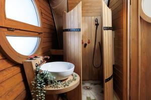 a small bathroom with a sink and a window at Glamping Spiritul Zimbrului in Vama Buzăului