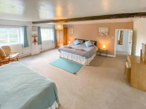 a large bedroom with a large bed in a room at Middle Farm in East Harling