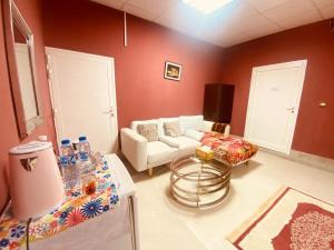 a living room with a couch and a table at Farmhouse One Bedroom Attached Bathroom in Al Rahba