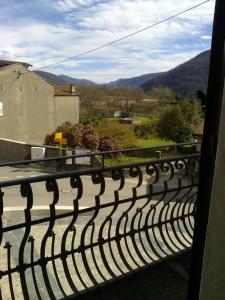 a railing on a balcony with mountains in the background at La taverna in Sessa