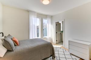 a white bedroom with a bed and a window at Chic and Modern Townhome 7 Mi to Downtown Nashville in Madison