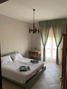 a bedroom with a bed and a large window at La Pepita in Vallo Torinese