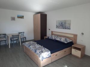 a bedroom with a bed and a table and chairs at Apartmani Gabrijel in Novi Vinodolski