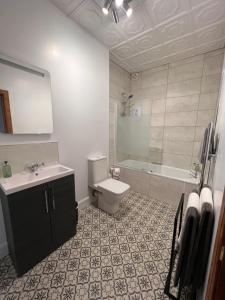 łazienka z toaletą, umywalką i wanną w obiekcie Morven Guest House Carnoustie w mieście Carnoustie