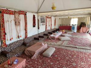 a room with couches and tables in a tent at stars camp oasis in Bawiti