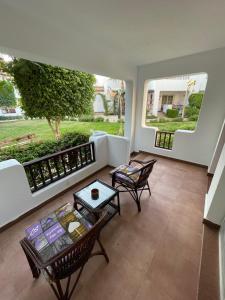 a living room with two chairs and a table at Delta Sharm Apartments with free Internet Wi-Fi in Sharm El Sheikh