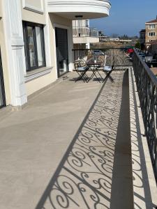 a balcony with a table and chairs on a building at Cosy apartments with sea view in complex PANORAMA in Chernomorets