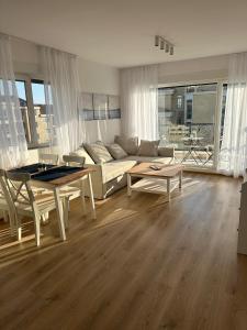 a living room with a couch and a table at Cosy apartments with sea view in complex PANORAMA in Chernomorets