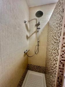 a bathroom with a shower with a shower head at Casita de Bolonia in Bolonia