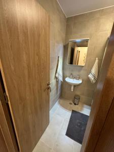 a bathroom with a sink and a mirror at Cosy apartments with sea view in complex PANORAMA in Chernomorets