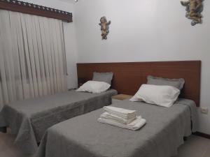 dos camas sentadas una al lado de la otra en una habitación en Vivenda das Eiras, en Vale de Porco