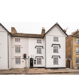 a white building on a street with a traffic light at Romney Home in Maidstone