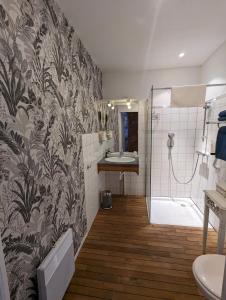 a bathroom with a shower and a sink at Logis Hotel La Tourelle du Beffroi in Bourbon-Lancy