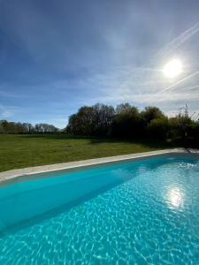 a large blue swimming pool in a field at La Gironnerie in Loché-sur-Indrois