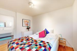 sypialnia z łóżkiem z kolorowym kocem w obiekcie Haabakk on Sea w mieście Tau