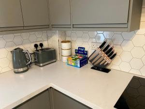 a kitchen counter top with items on it at Luxury Riverside City Centre Apartment in York