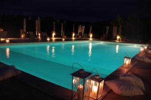 a swimming pool lit up at night with lights at Agriturismo Tara in Amelia