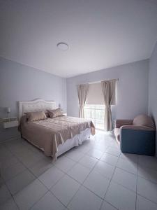 a bedroom with a large bed and a window at COMPLEJO ECHAGUE in San Juan