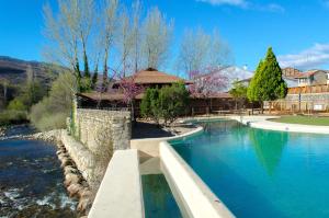 a swimming pool in the middle of a river at Hospedería Valle del Jerte in Jerte