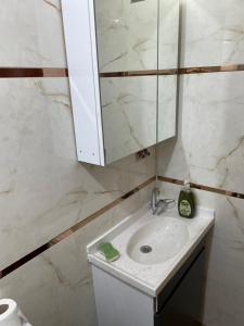 a bathroom with a sink and a mirror at Can’s Homes in Kuşadası +44 photos