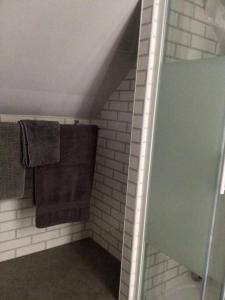 a bathroom with a shower with brown towels at Prestatyn Loft in Prestatyn