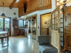 a living room with a table and a chair at Appartement La Clusaz, 3 pièces, 6 personnes - FR-1-437-44 in La Clusaz