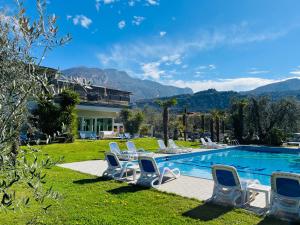 a villa with a swimming pool with lounge chairs at Villa Franca in Nago-Torbole