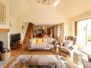 a living room with two couches and a tv at The Orchard in Knighton