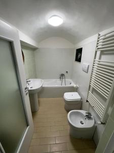 a bathroom with a toilet and a tub and a sink at Casa Marta in Cava deʼ Tirreni