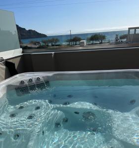 a bath tub with a view of the ocean at Belvedere Luxury Apartments & Spa in Plakias