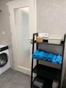 a shelf in a kitchen with a washing machine at Nové bývanie v centre Košíc. in Košice